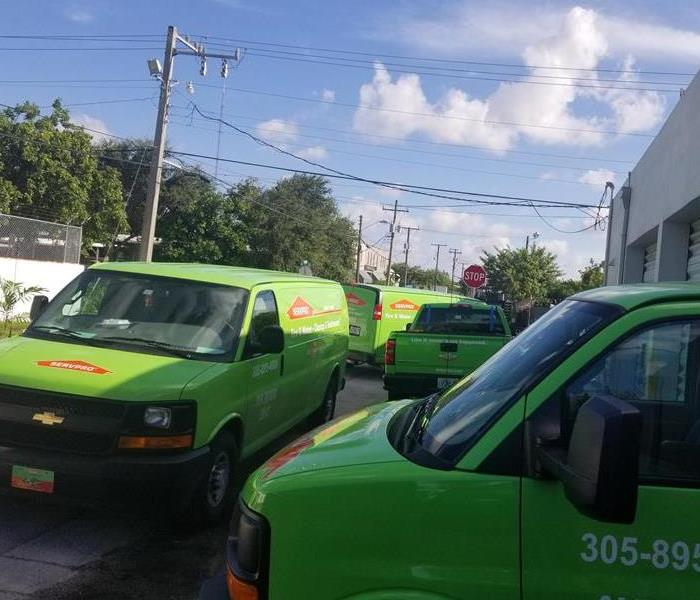 Green SERVPRO trucks outside