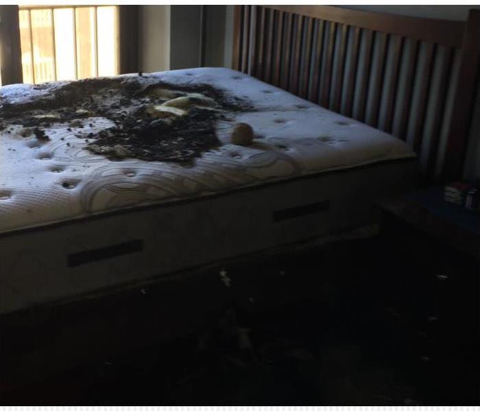 A bedroom with fire damage