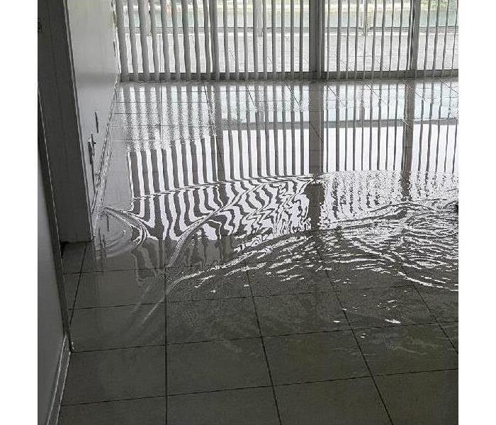 clear water on the floor, water damage in commercial building, standing water